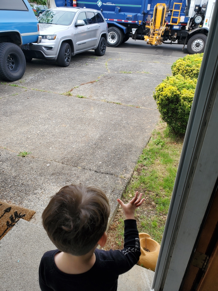 Kamden waving to truck.